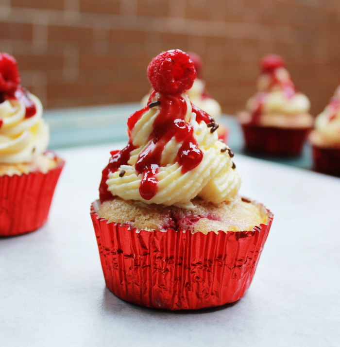 raspberry cupcakes with a white chocolate ganache frosting